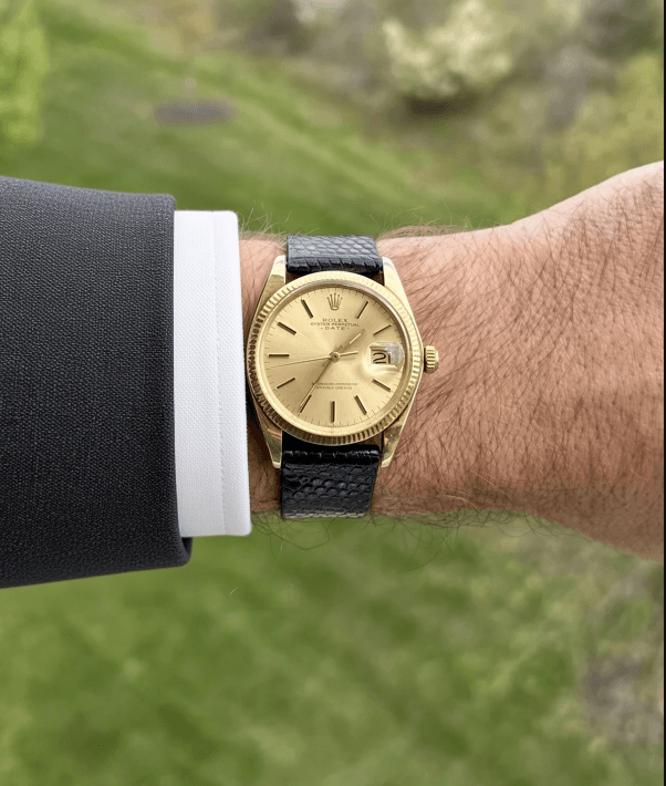 Vintage gold Rolex Datejust worn on a wrist outdoors